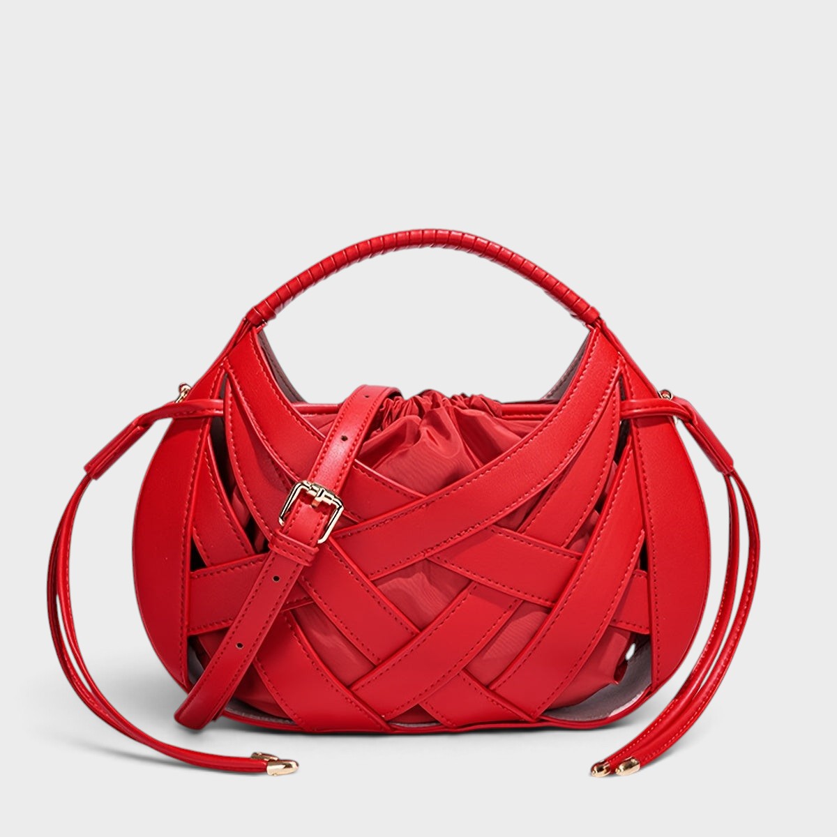 VALENORA Ruby red vegan leather handbag with a structured lattice overlay and soft drawstring interior pouch.