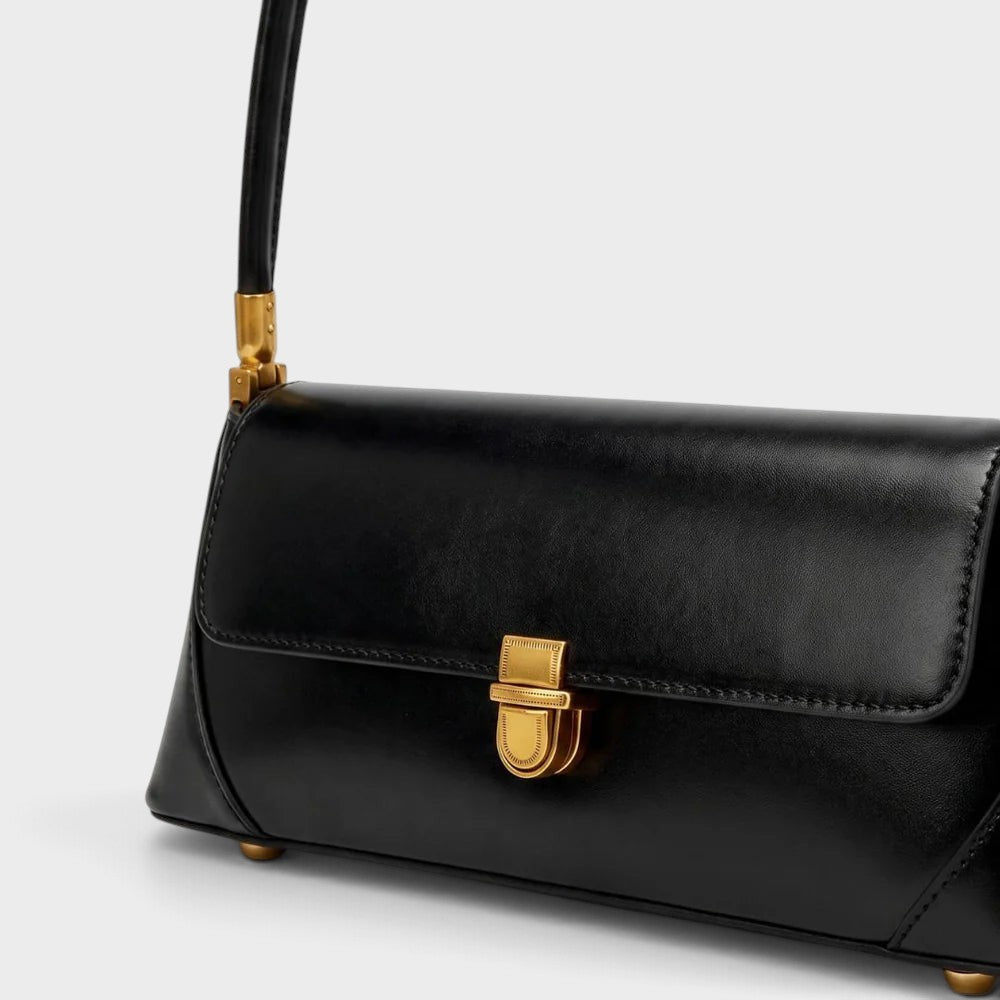 VALENORA Amancia black synthetic leather baguette shoulder bag with gold-toned clasp hardware and structured base.