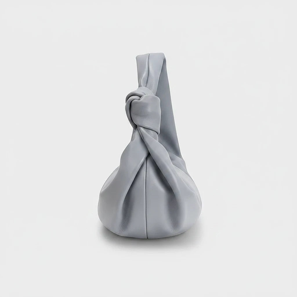 VALENORA Amanda handbag in cloudy blue vegan leather with a soft, rounded silhouette and a knotted shoulder strap.