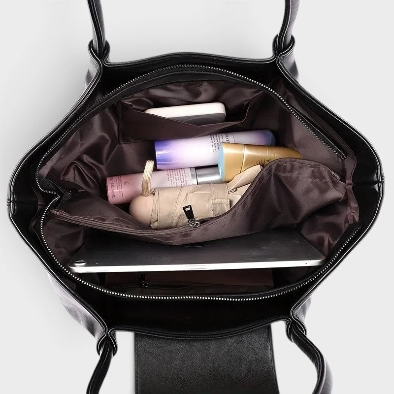 VALENORA Amara black vegan leather tote bag interior view showing organized compartments with daily essentials