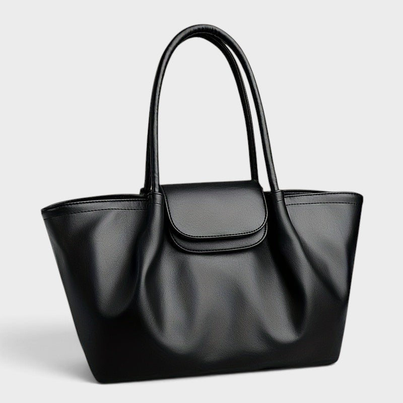 VALENORA Amara black vegan leather tote bag with a structured boxy silhouette, dual shoulder straps, and buckle flap.