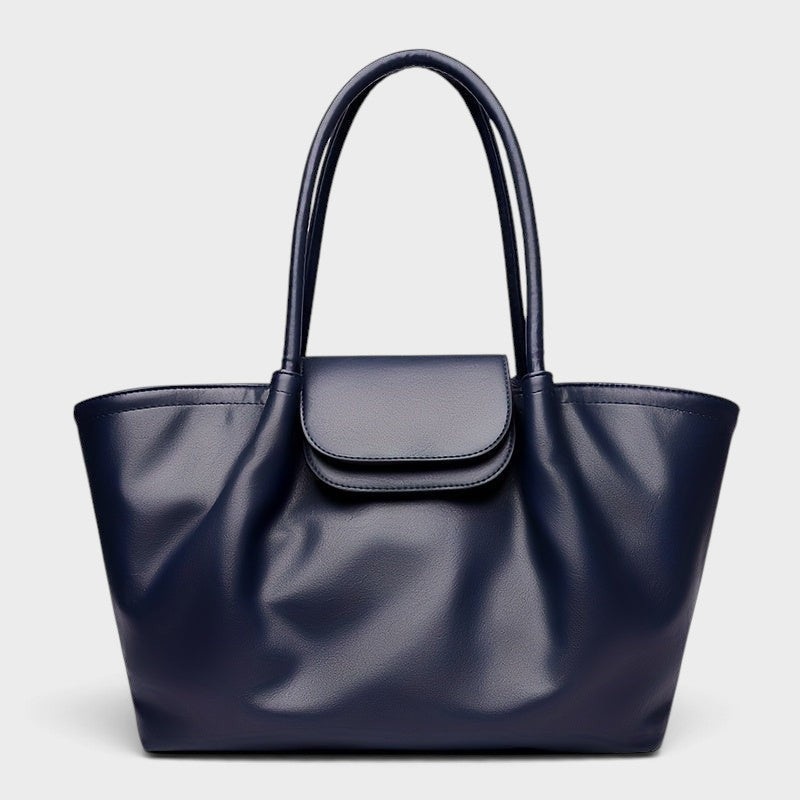 VALENORA Amara navy blue vegan leather tote bag with a structured boxy silhouette and front flap buckle closure.