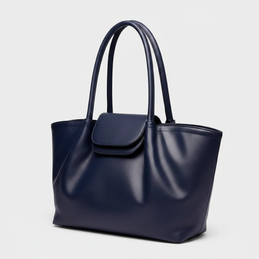 VALENORA Amara navy blue vegan leather tote bag with dual shoulder straps and a front flap buckle closure.