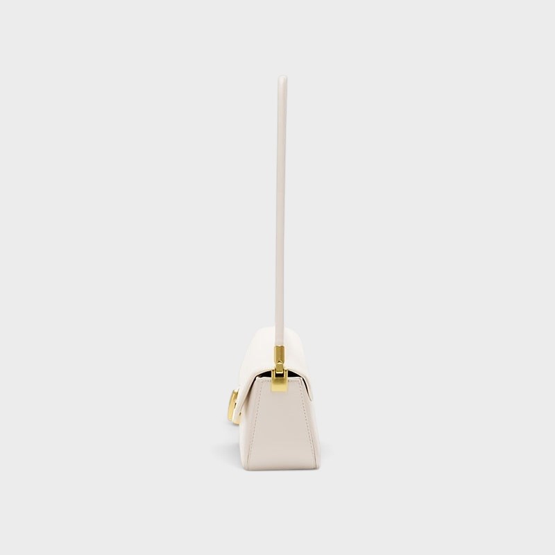 VALENORA Bianca cream microfiber leather shoulder bag with a structured silhouette and gold link clasp, side view.