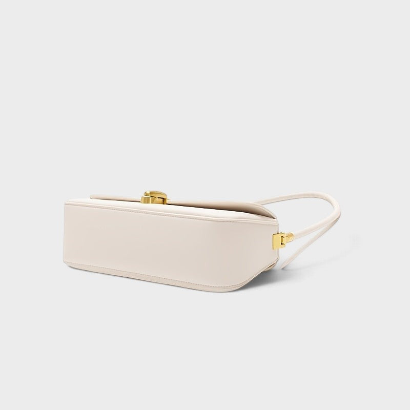 VALENORA Bianca cream microfiber leather shoulder bag with a gold link-style clasp, shown from a side angle.