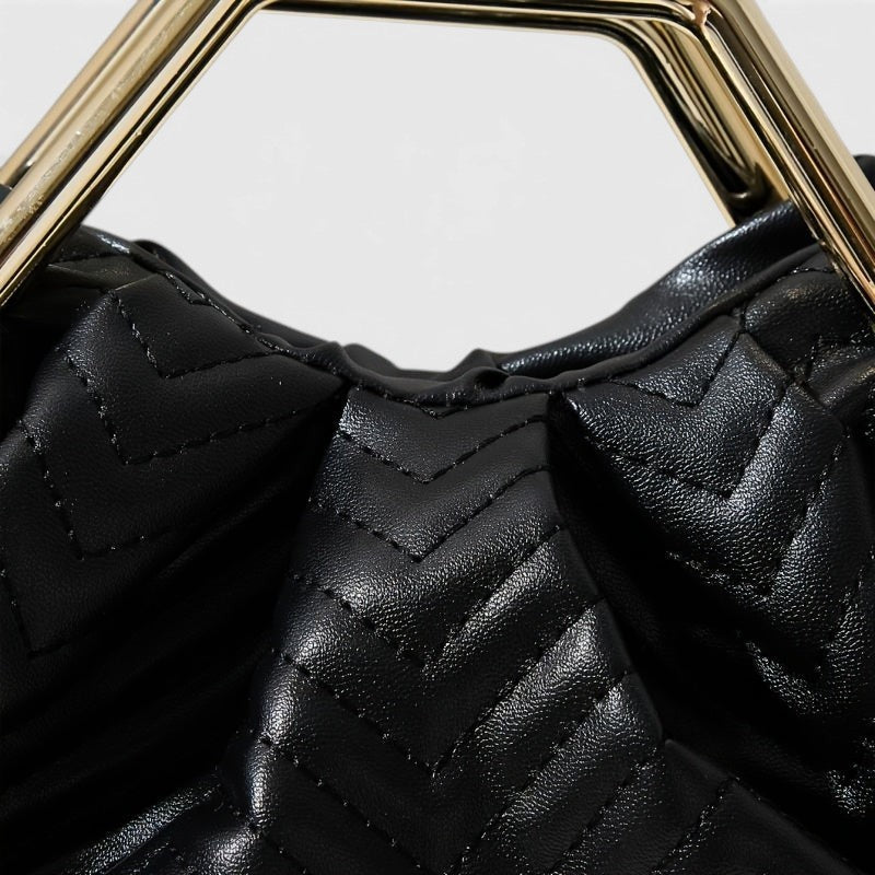 VALENORA Norah black vegan leather handbag with a textured herringbone pattern and a gold-tone metal handle.