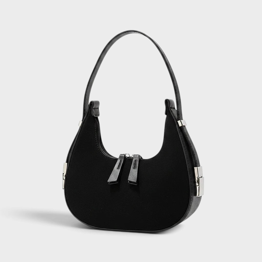 VALENORA French black suede and leather shoulder bag with a rounded silhouette and silver hardware details.