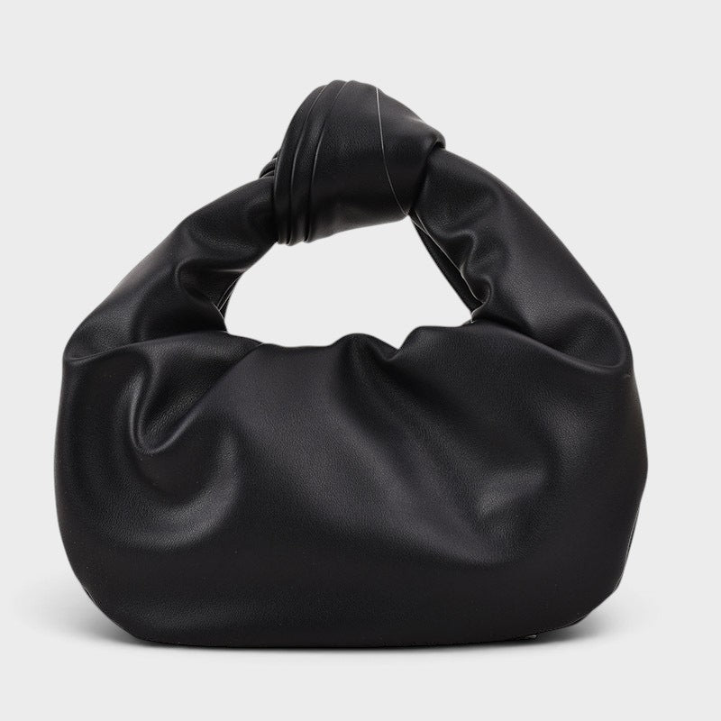 VALENORA black vegan leather handbag with a soft matte finish and a unique knotted top handle design.