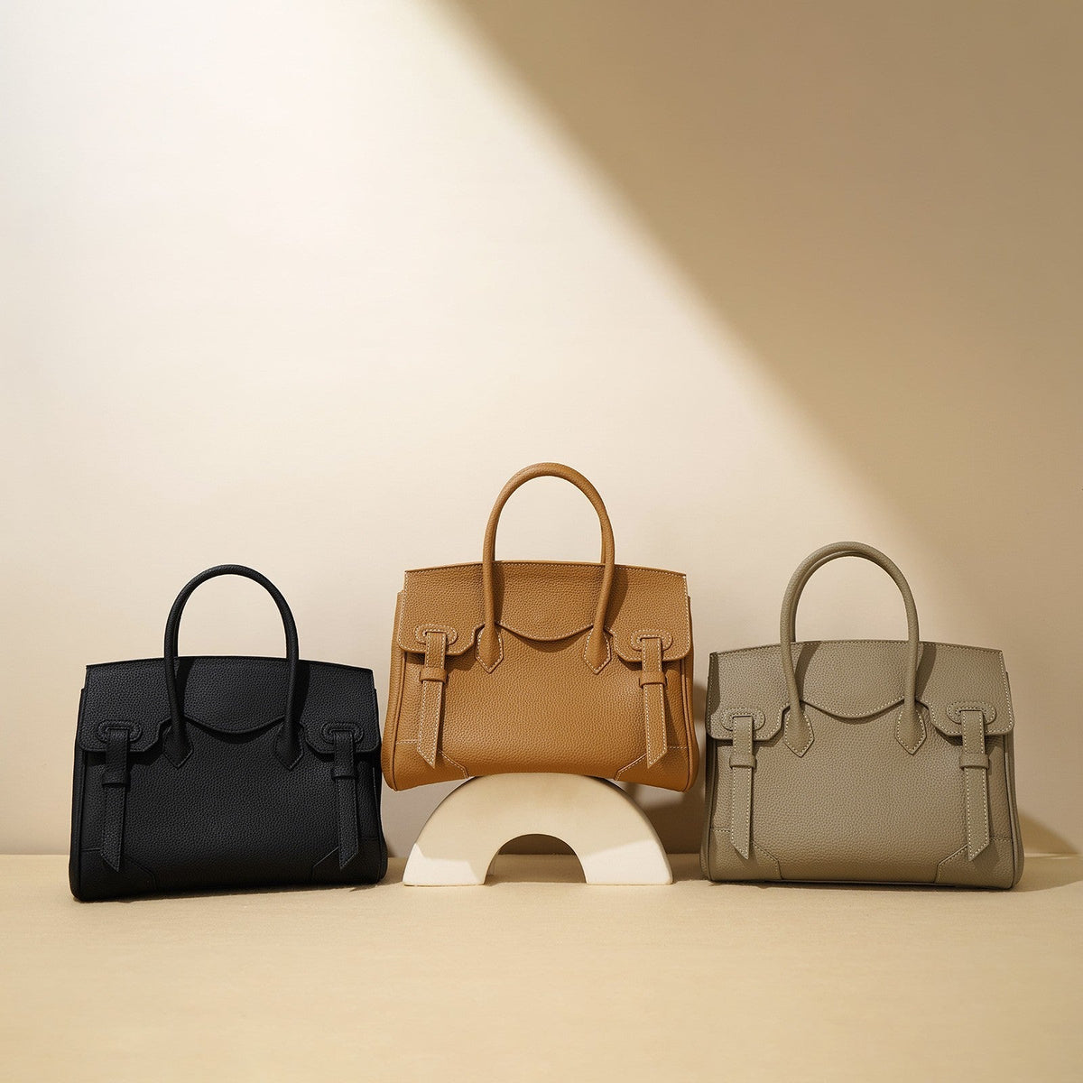 VALENORA Brittany leather tote handbags in black, amber, and glacier gray with structured minimalist design.
