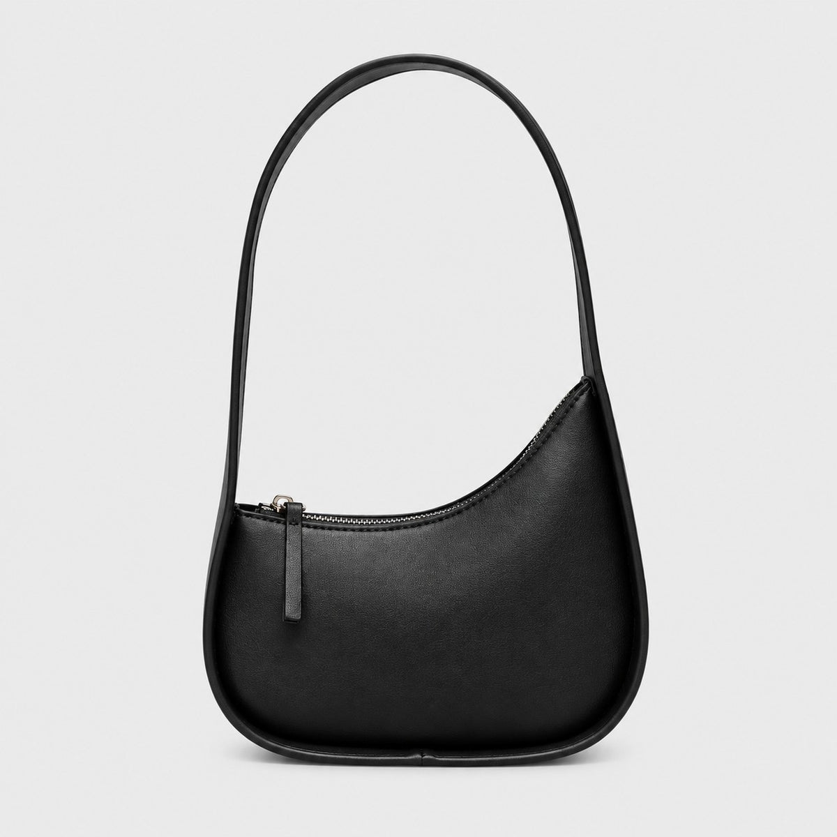 VALENORA Brooklyn shoulder bag in black genuine leather with a curved crescent silhouette and gold-tone zipper.