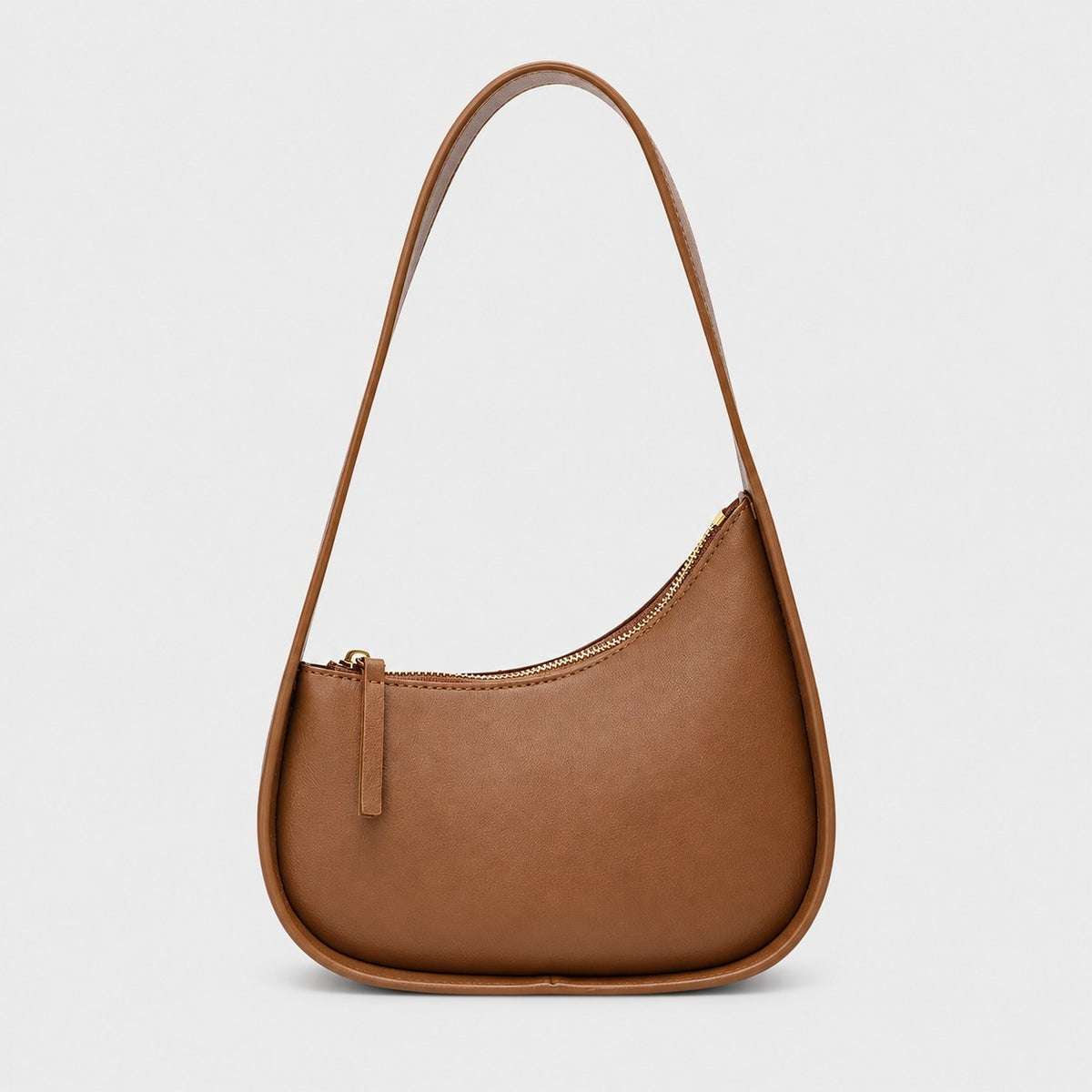 VALENORA Brooklyn crescent shoulder bag in caramel genuine leather with a gold-tone zipper and wide shoulder strap.
