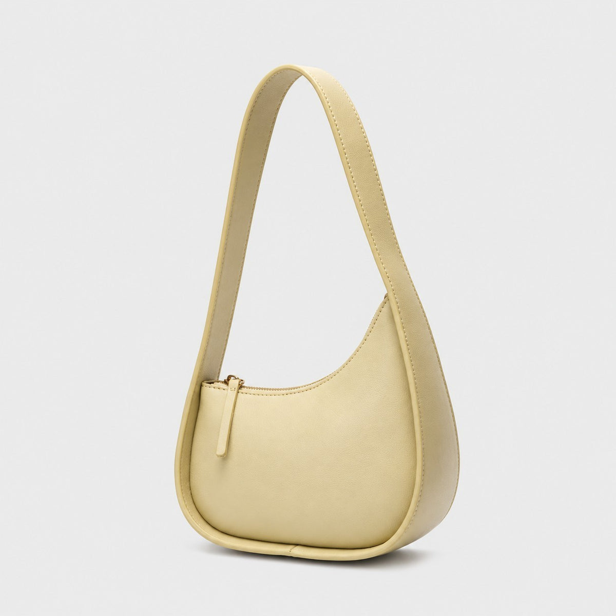 VALENORA Brooklyn shoulder bag in light yellow genuine leather with a crescent silhouette and gold-tone zipper.