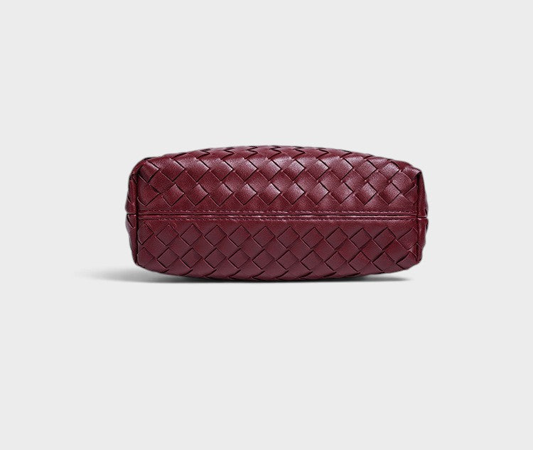 VALENORA Adele crossbody bag in deep burgundy with an intricate woven leather texture, shown from the base view.
