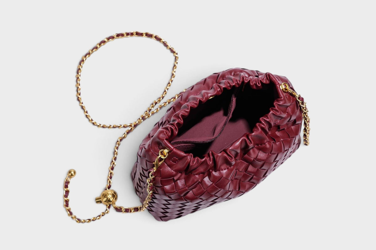 VALENORA burgundy woven leather shoulder bag with a gathered top and adjustable gold-tone chain strap