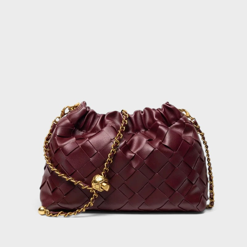 VALENORA burgundy woven leather shoulder bag with a gathered top and gold-tone chain strap on a white background.
