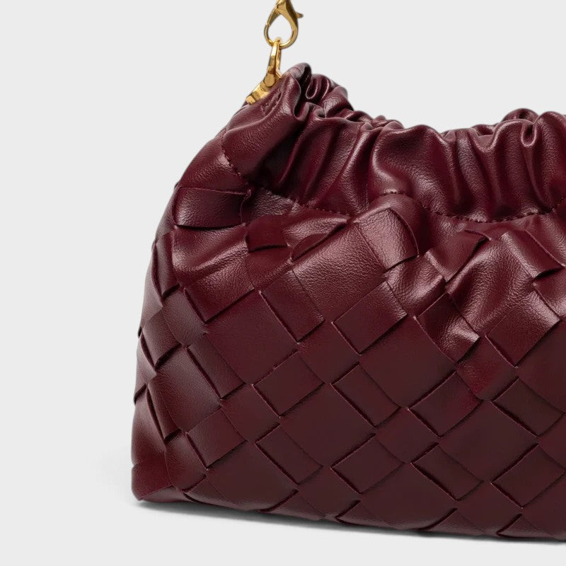 VALENORA Adele burgundy woven leather shoulder bag with a gathered top and gold-tone chain strap detail.
