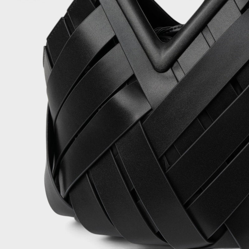 VALENORA Celia handbag featuring a black woven leather exterior with a structured geometric design