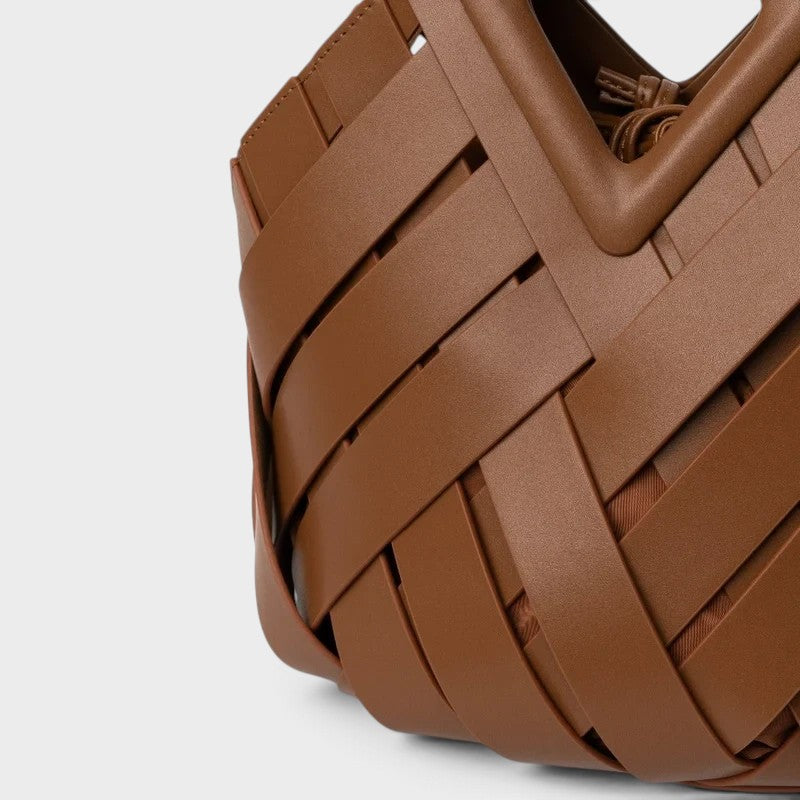 VALENORA Celia handbag in brown woven leather with a geometric architectural silhouette and smooth finish.