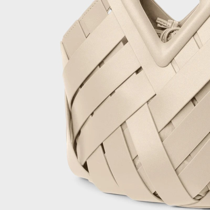 VALENORA Celia handbag in cream woven leather with a structured geometric silhouette and architectural design.