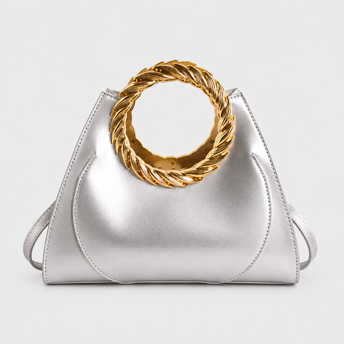 VALENORA Cleo metallic silver vegan leather handbag featuring a bold rope-twisted gold ring handle.