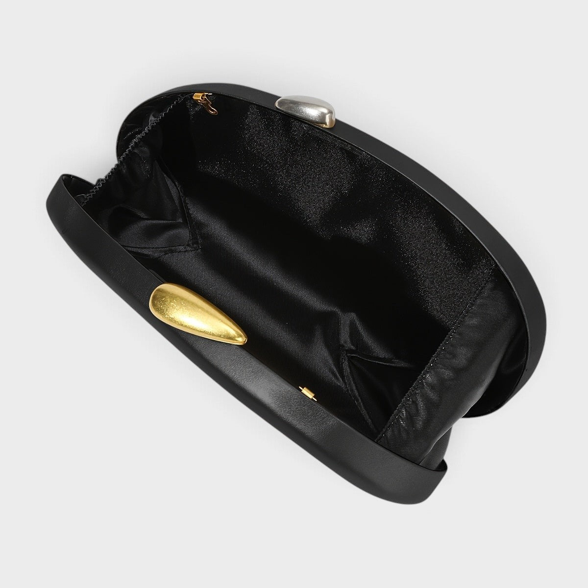 VALENORA Cosette black vegan leather clutch bag with a unique two-tone gold and silver metal clasp, open interior view