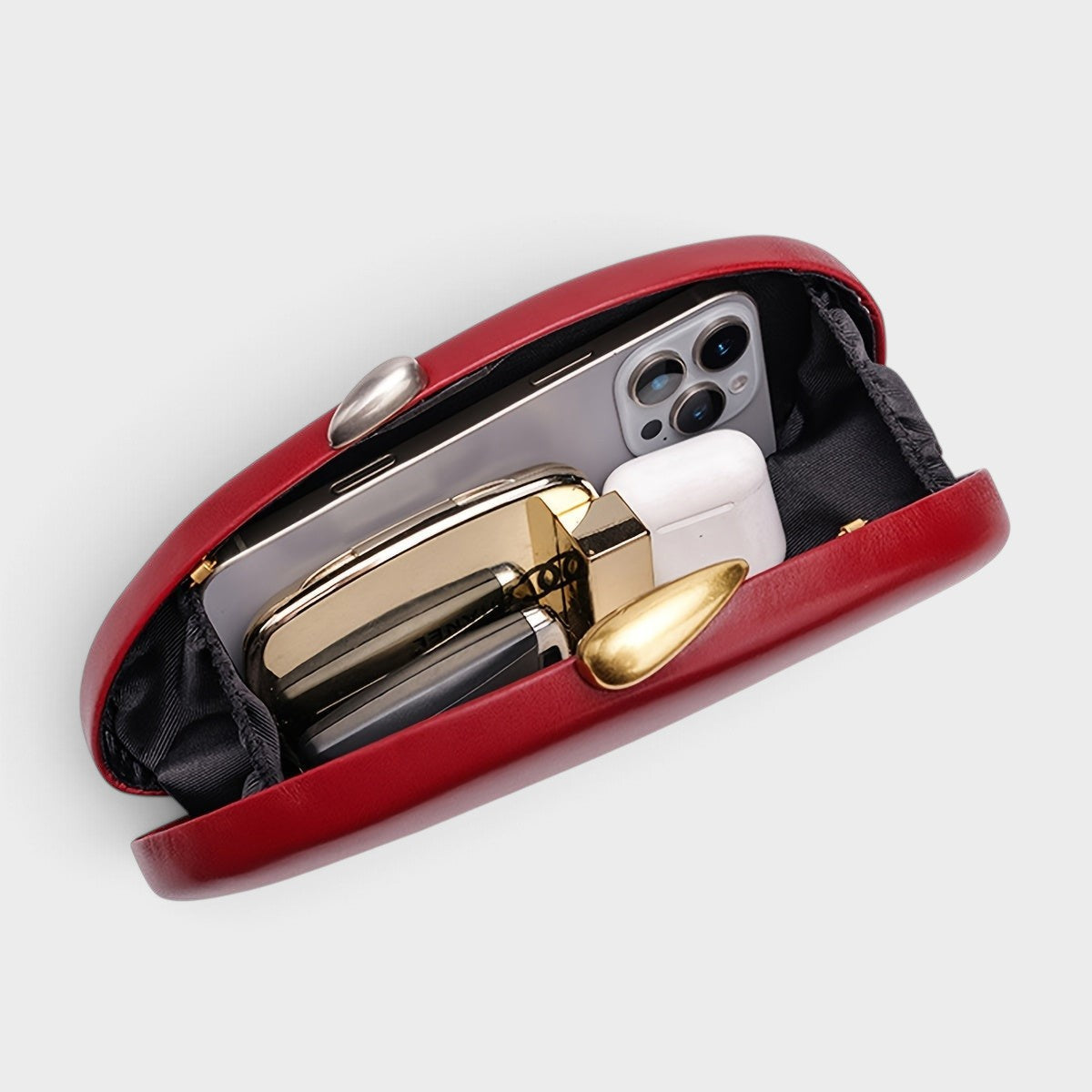 VALENORA Cosette red vegan leather clutch bag with gold and silver two-tone clasp, shown open with interior contents.