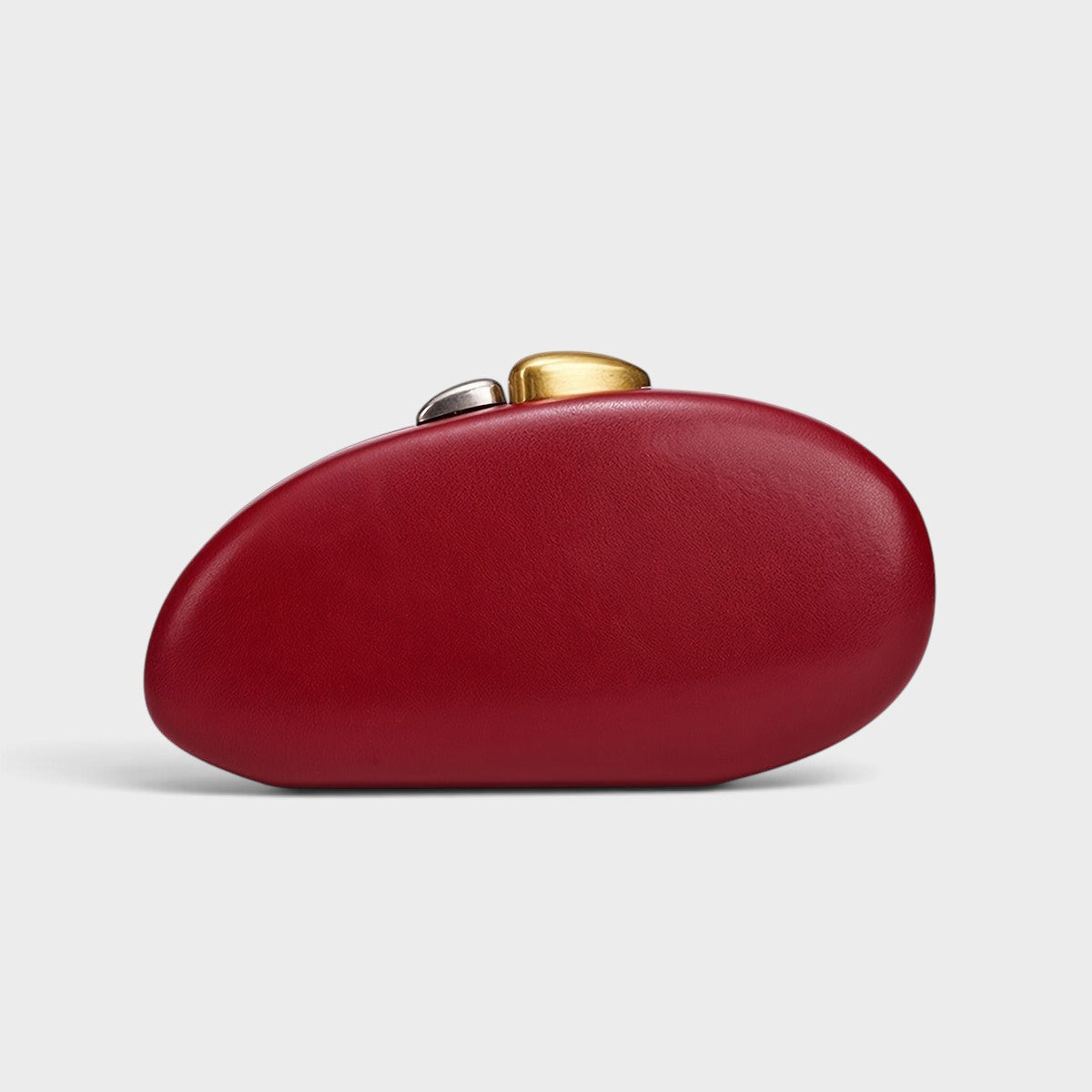 VALENORA Cosette red vegan leather clutch with a rounded pebble shape and mixed gold and silver metal clasp
