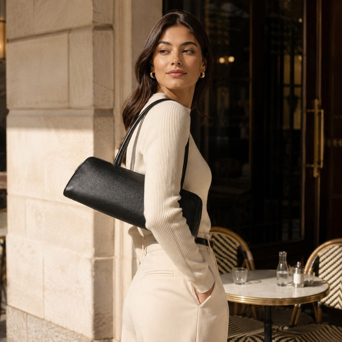 VALENORA Elsbeth black cowhide leather shoulder bag with fixed straps worn by a woman in a casual outfit