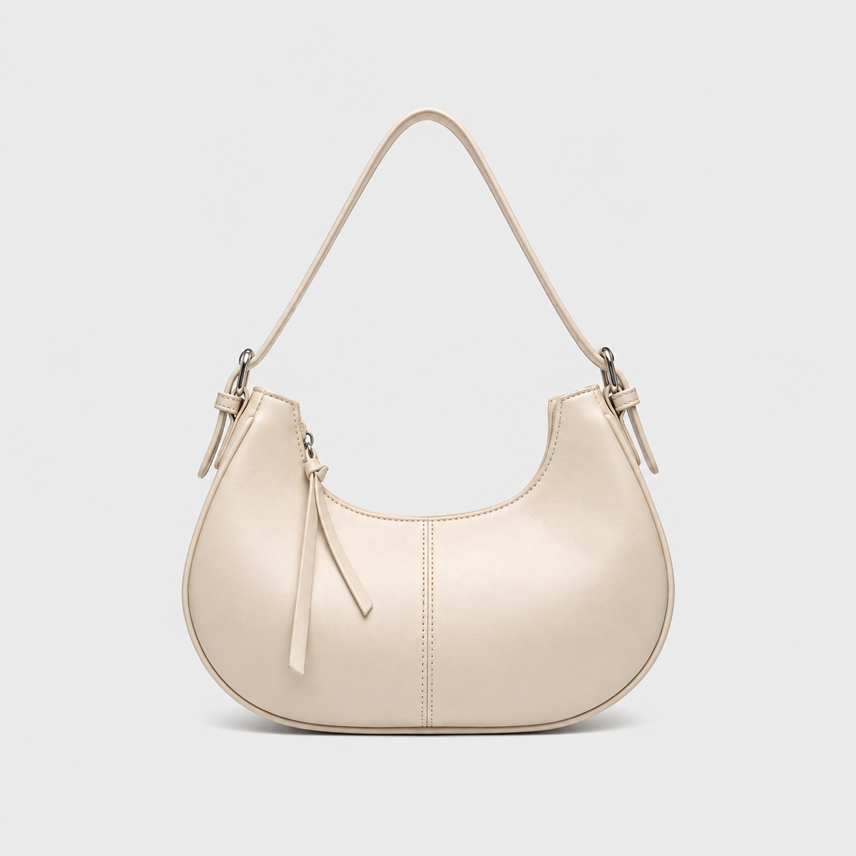 VALENORA Frange shoulder bag in creamy white vegan leather with a rounded silhouette, zip closure, and fringe pull.