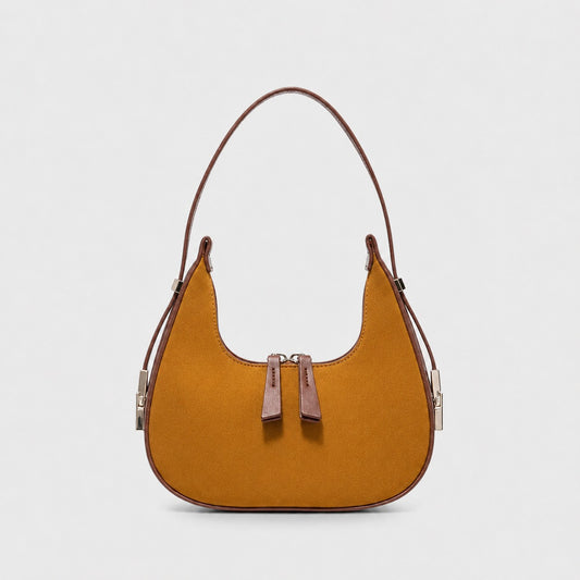 VALENORA French shoulder bag in brown suede with leather trim and a rounded silhouette on a light grey background.