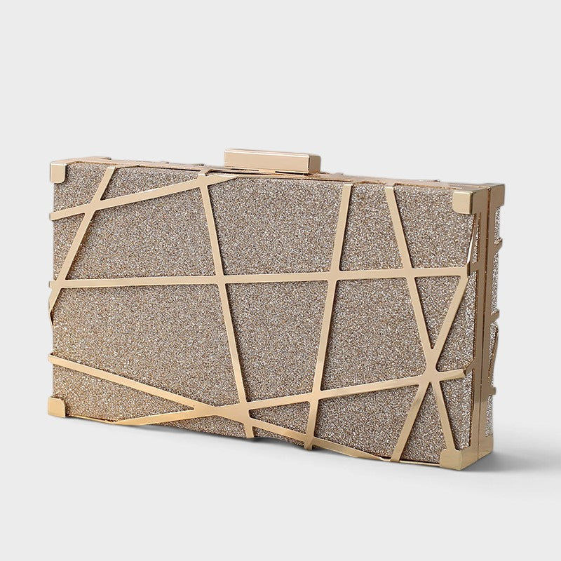VALENORA geometric clutch in a shimmering gold metallic finish with sharp angular lines for an elegant evening look.