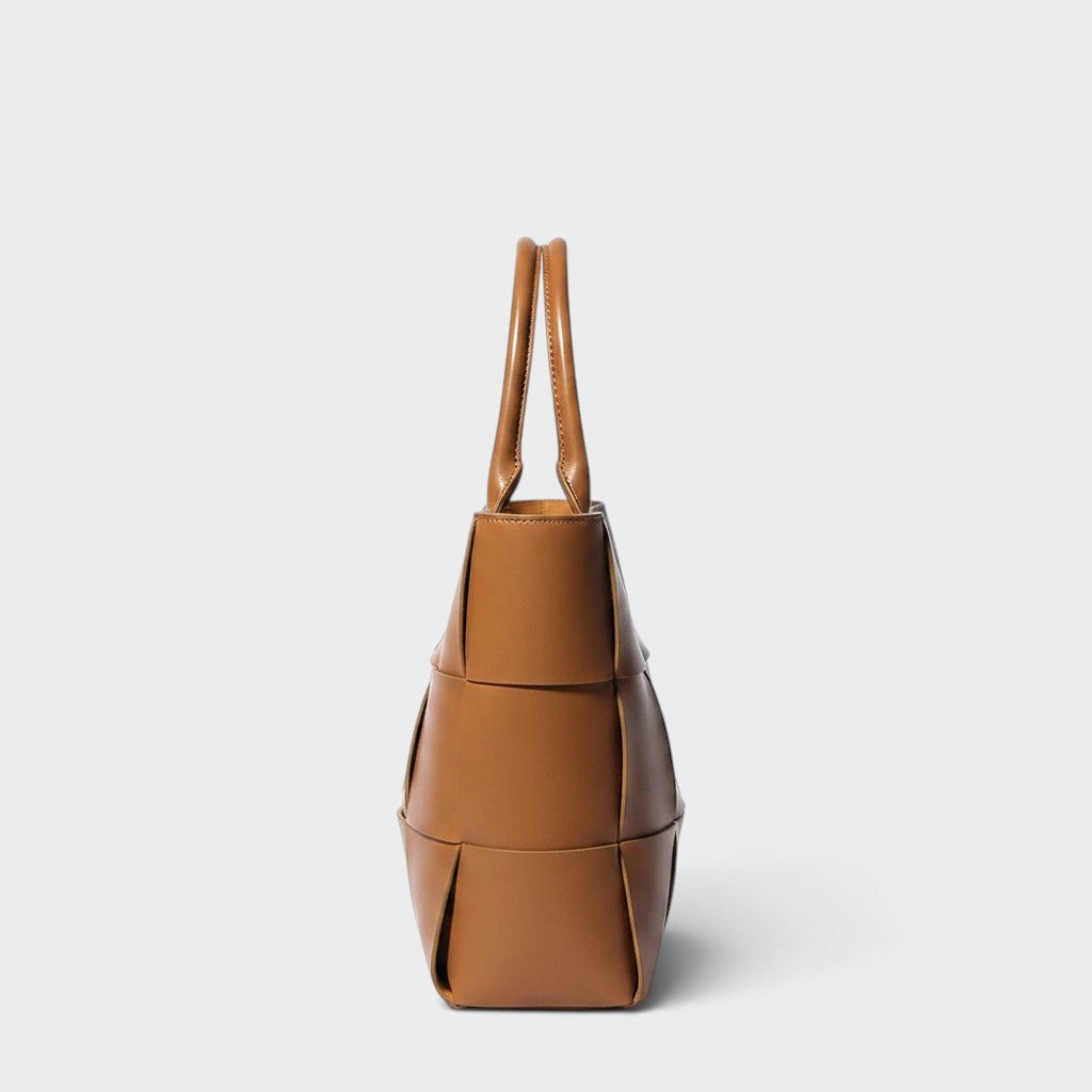 VALENORA Helene brown woven leather tote bag, side view showing structured shape and minimalist design.
