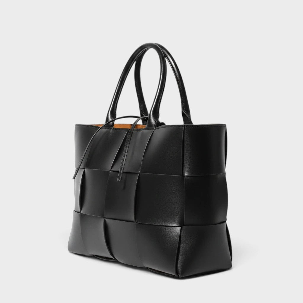 VALENORA Helene black tote bag featuring a woven leather texture and structured design on a light grey background.