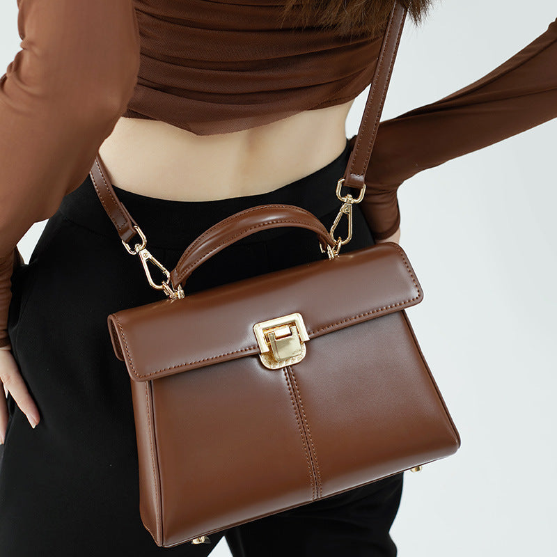 VALENORA Henna dark brown genuine leather crossbody handbag with a structured rectangular shape and gold hardware.