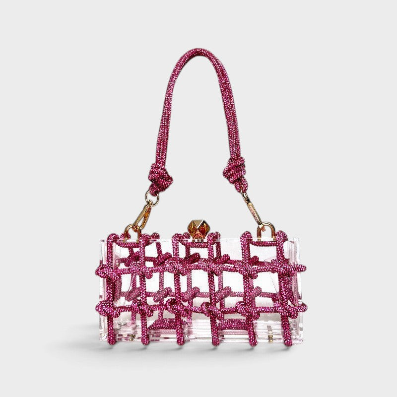 VALENORA Isabelle clear acrylic clutch bag with a vibrant pink knotted crystal lattice overlay and top handle
