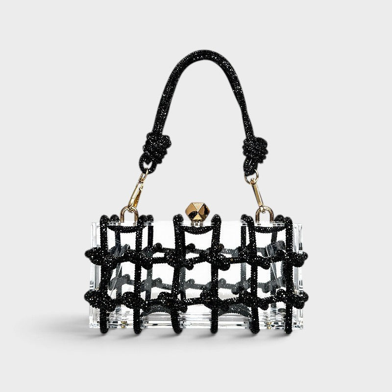 VALENORA Isabelle transparent acrylic clutch bag with a black beaded grid overlay and matching beaded handle.
