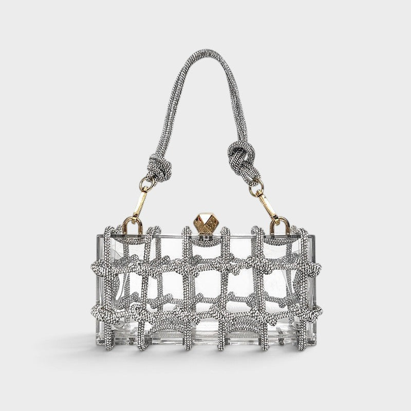 VALENORA Isabelle transparent acrylic clutch bag with silver crystal-embellished grid overlay and knotted handle