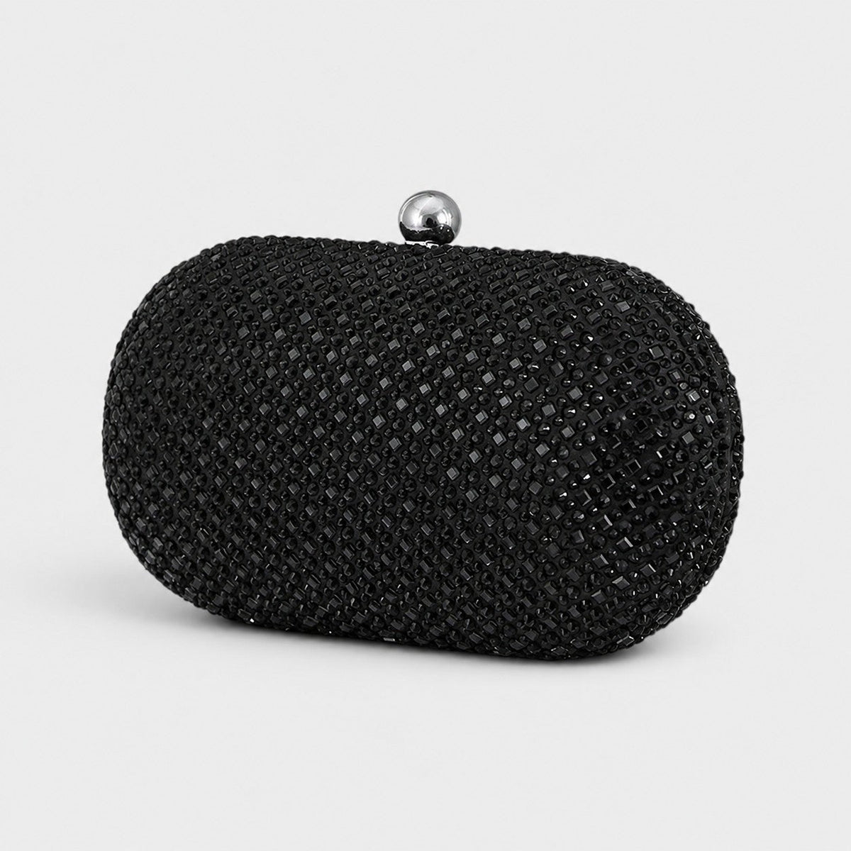 VALENORA Ismay oval clutch bag covered in sparkling black crystals with a polished silver-tone ball clasp closure.
