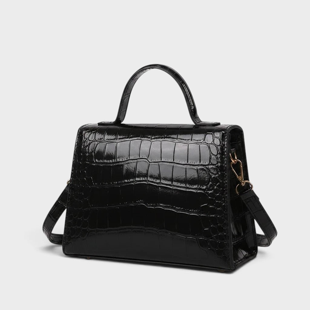 VALENORA Kelly black genuine leather crossbody handbag with a glossy crocodile-embossed texture and top handle.