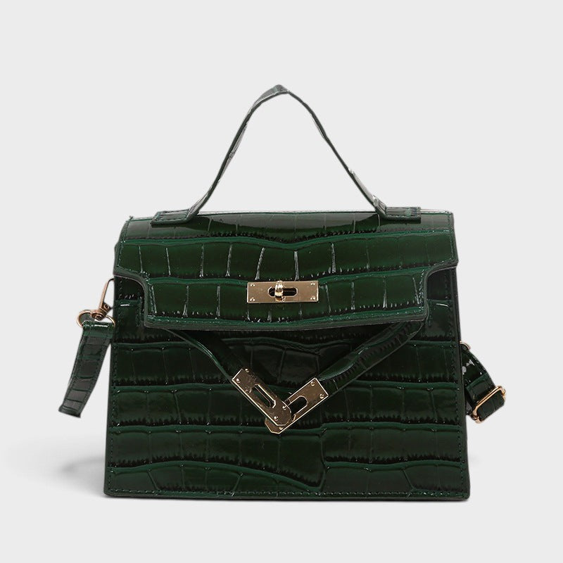 VALENORA Kelly crossbody handbag in dark green genuine leather with a glossy crocodile-embossed texture and gold clasp.