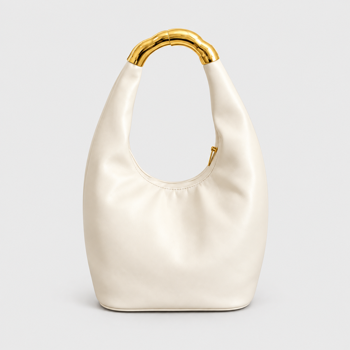 VALENORA Liana beige vegan leather shoulder bag with a sculptural bamboo-textured gold ring handle.