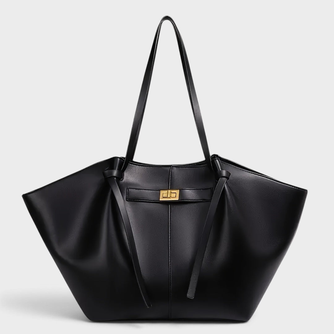 VALENORA Madison black leather tote bag with a sculptural knotted top handle and gold-tone turn-lock closure.