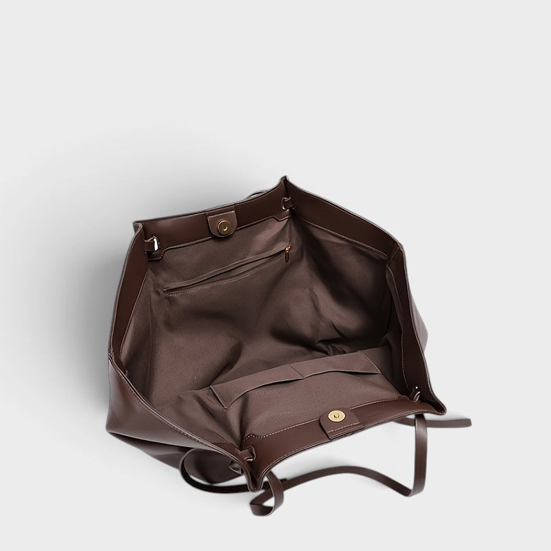 VALENORA Madison leather tote bag interior view showing brown fabric lining, pockets, and magnetic snap closure.