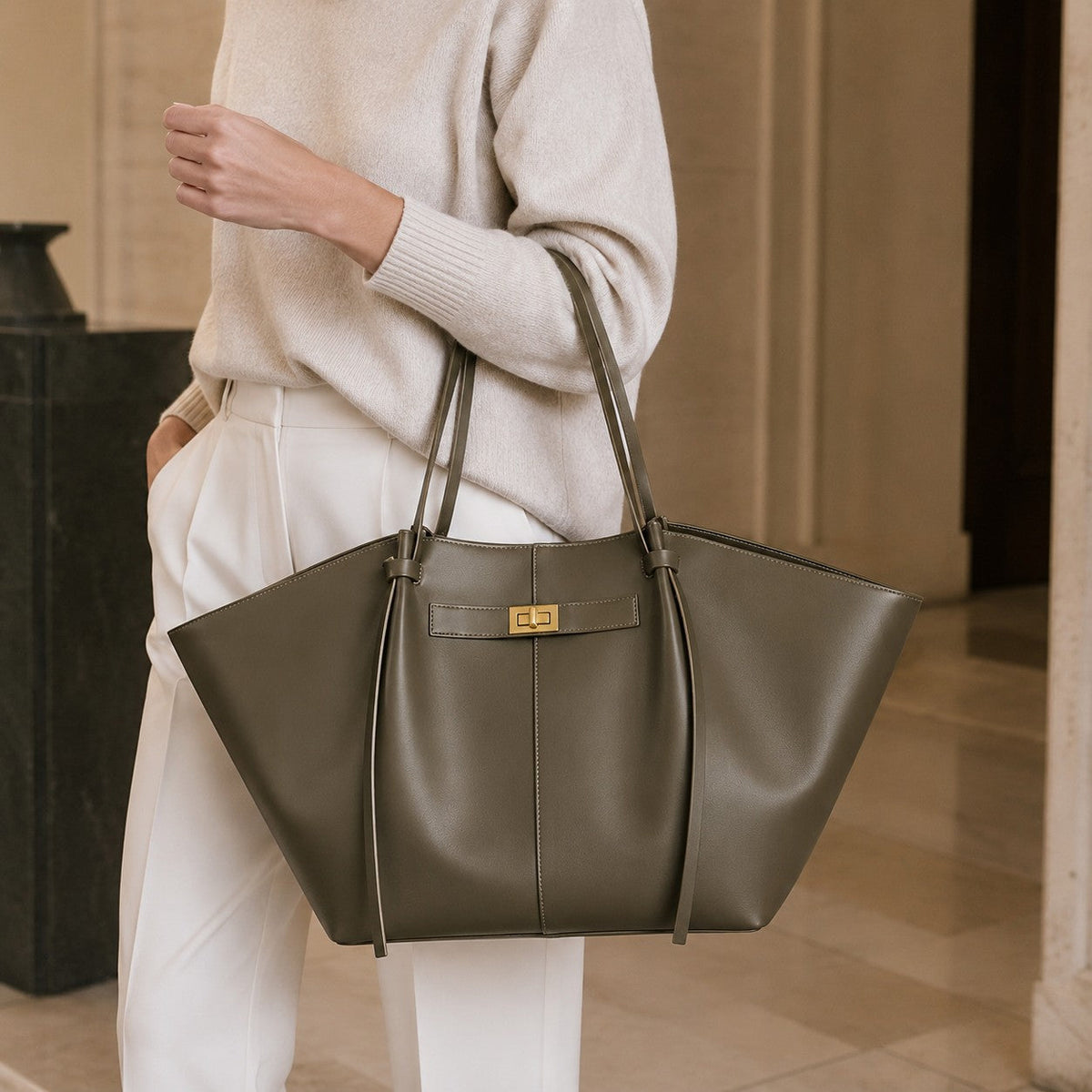 VALENORA Madison leather tote bag in olive green with a sculptural knotted handle and gold hardware.
