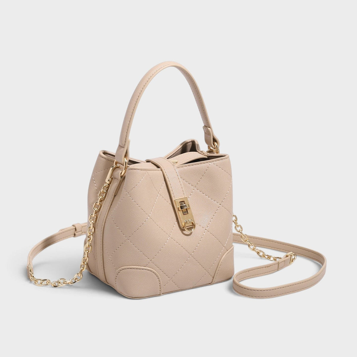 VALENORA Margot beige quilted vegan leather bucket bag with gold turn-lock closure and chain shoulder strap