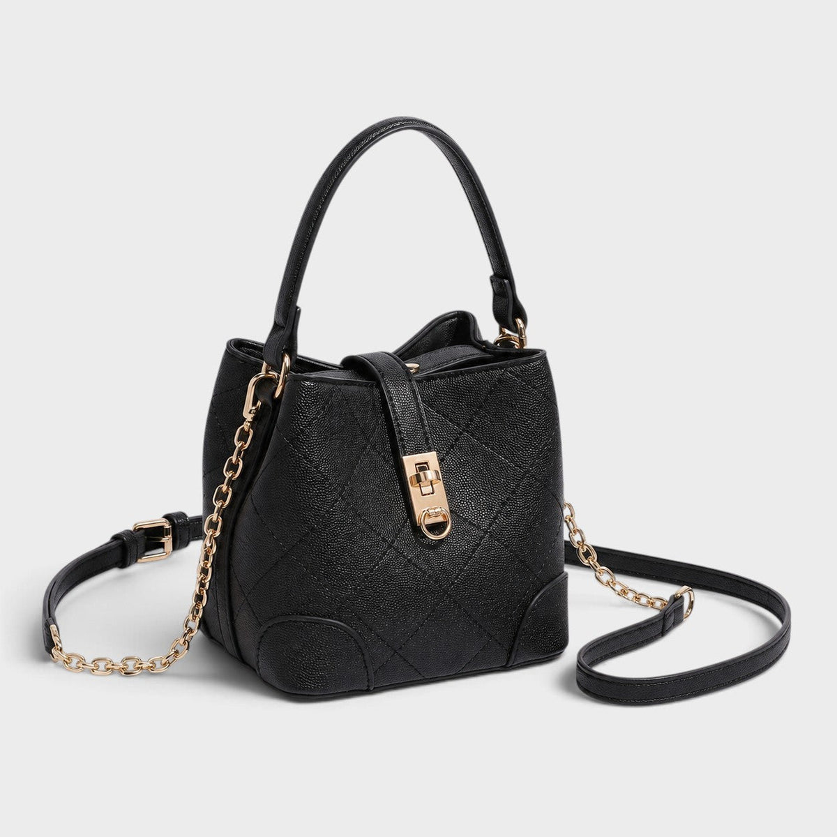 VALENORA Margot black quilted vegan leather bucket shoulder bag with gold turn-lock closure and chain strap detail.