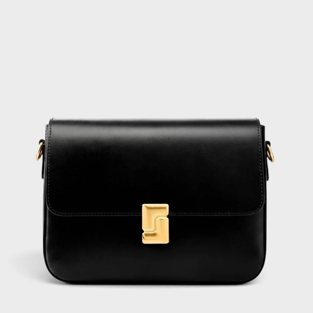 VALENORA Marisa black cowhide leather shoulder bag with a structured flap and sculptural gold-tone buckle closure