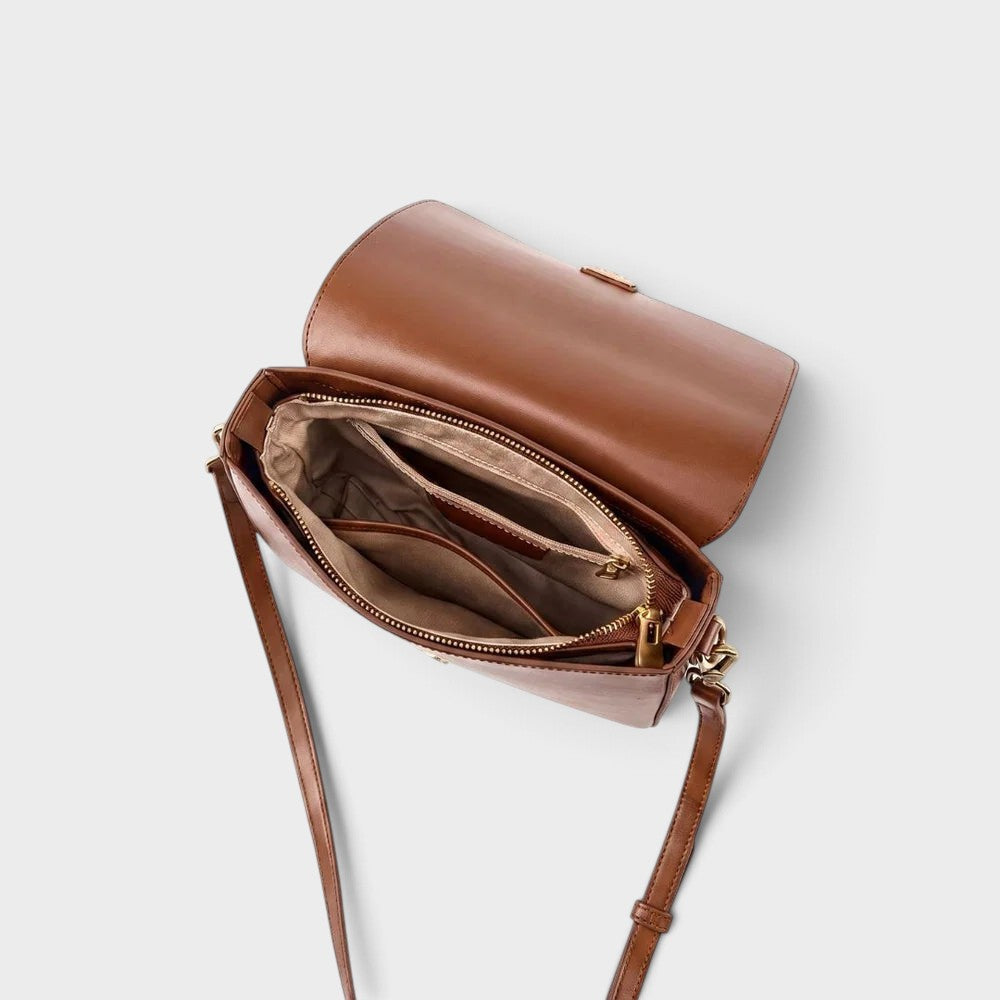 VALENORA Marisa brown cowhide leather shoulder bag with open flap and interior pockets showing structured design