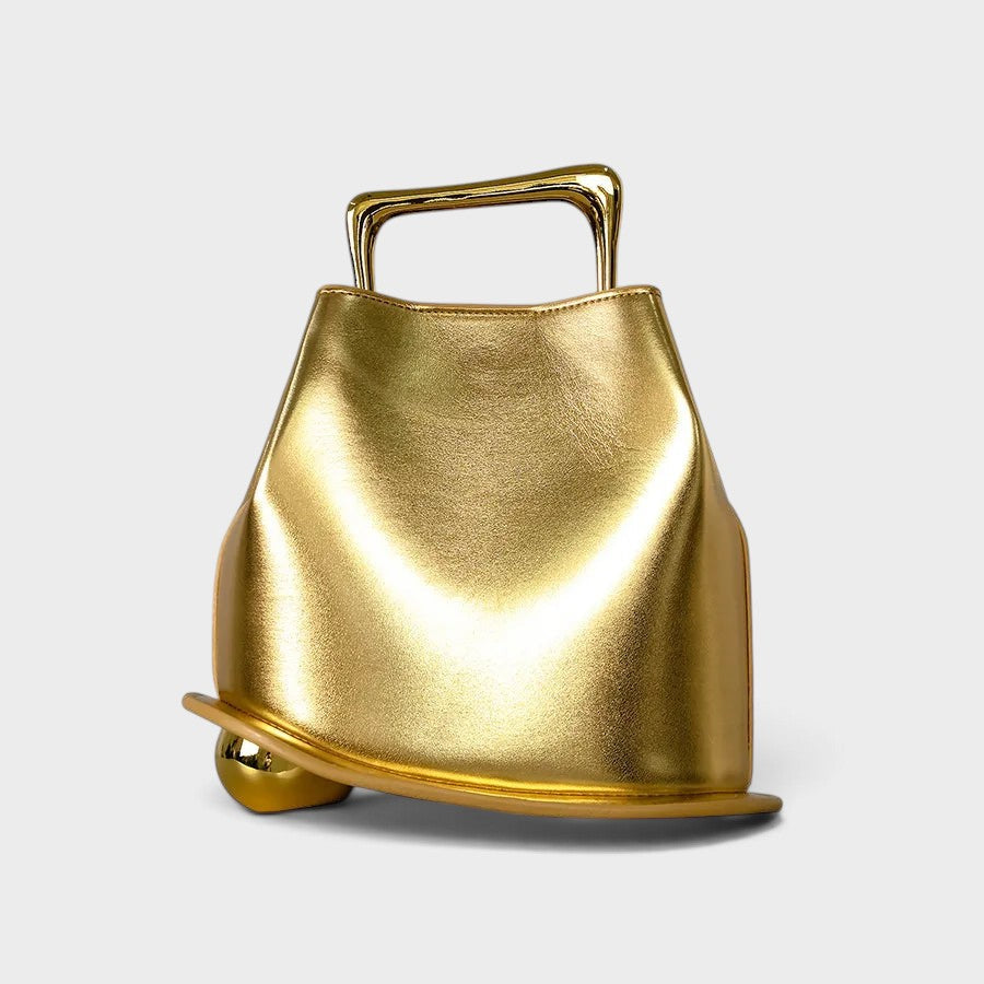 VALENORA Marisol handbag in metallic gold with a sculptural architectural silhouette and polished gold-tone handle.