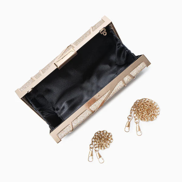 VALENORA geometric metallic gold clutch with open interior and detachable gold chain strap on a white background.